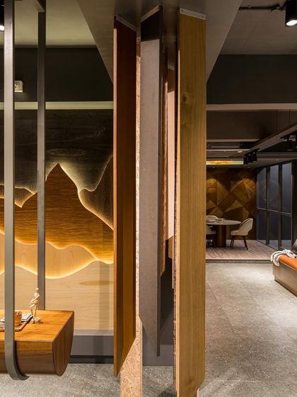 The design of the showroom itself serves as a platform for the merchandise, with veneer used in artistic and architectural applications throughout.