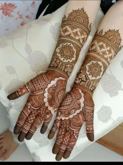 A lovely bridal design with paisley and mandala elements. The patterns are designed to complement the bride's hands and attire.