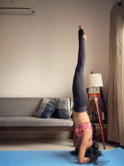 Headstanding through life. A still shot of a fully extended Shirshasana, showcasing the strength and alignment needed to hold the pose.