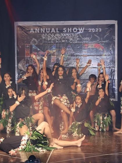 This scene from the tribal performance tells a story through character interaction and dramatic posing, engaging the audience in the narrative.