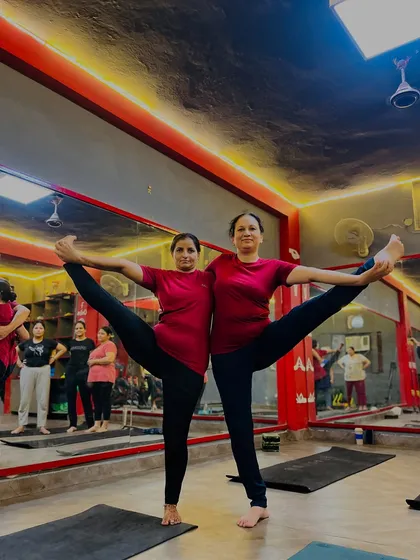 Perfect synchronization in a partner standing split. This demonstrates the focus and connection developed in my sessions.