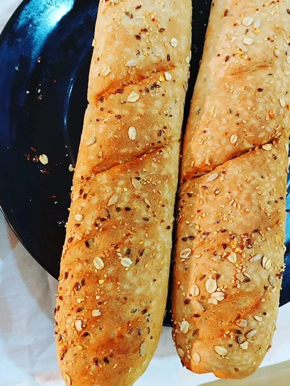 Freshly baked multigrain baguettes made by students in our baking diploma course. We focus on teaching the fundamentals of artisan bread making, a key skill for any professional bakery.