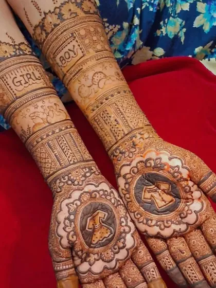 A simple yet sweet baby shower mehendi. The palms feature illustrations of a baby dress and shirt, with the words 'GIRL' and 'BOY' written on the arms.