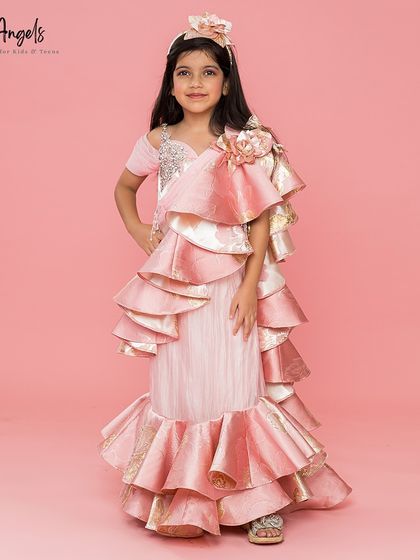 The full view of our jacquard drape saree shows the unique silhouette with its ruffled mermaid style bottom.