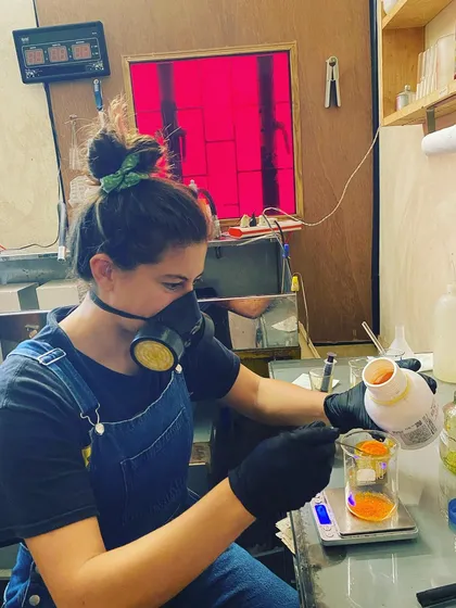 An artist carefully measures chemicals in our darkroom while learning the tri-color Gum Bichromate process. We offer guided sessions for artists looking to deepen their knowledge of alternative printing techniques.