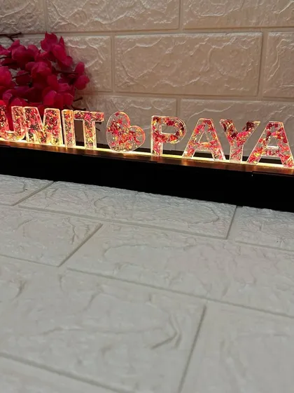 The LED name stand shown from a distance, illustrating how it looks as a decorative lamp on a tabletop.