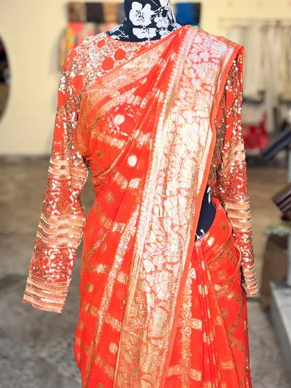 Another angle of the 'SONDARYA' saree, highlighting the craftsmanship on the blouse sleeves and the border. It’s a perfect blend of tradition and contemporary style.