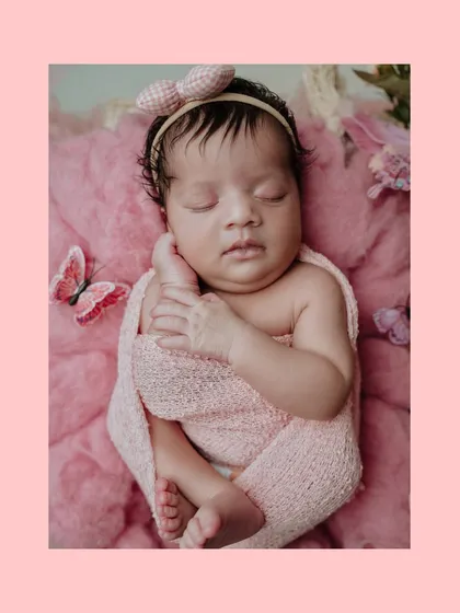 This is an example of a themed newborn portrait session. For this baby girl's photoshoot, I used a soft pink color palette, a gentle swaddle, and delicate butterfly props to create a sweet and dreamy image.