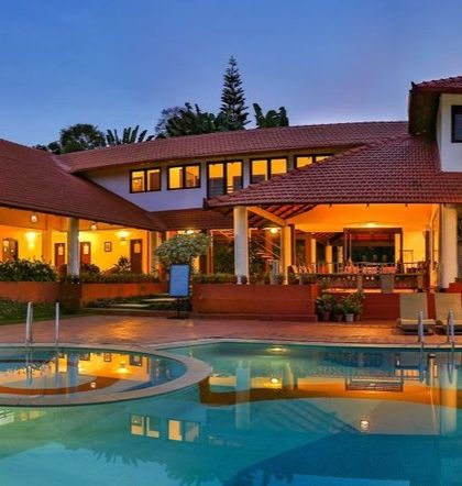 The beautiful poolside area of Riverside Nature Resort at dusk, a perfect place to relax with family and friends.