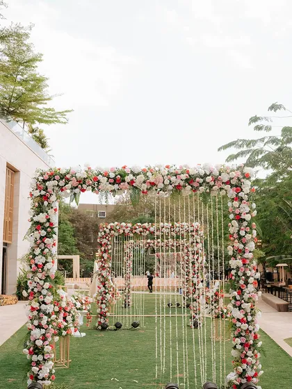 Imagine walking towards your forever through a dreamy pathway of floral arches. We design immersive entrances like this one to make your journey to the mandap feel truly spectacular.
