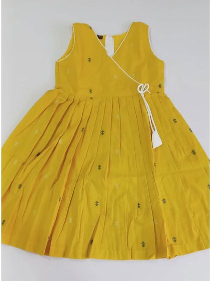 This is the turmeric yellow version of our Abhirami angrakha-style top. The pleated design and side tassel make it a stylish and comfortable choice for your little girl.