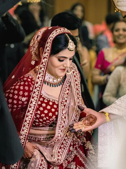 The groom extends his hand to help his bride onto the stage, a small gesture of a lifetime of support.
