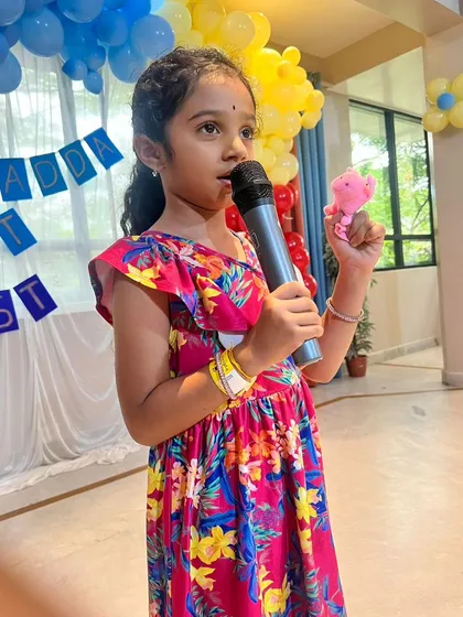 Confidence blooms on stage. Here, a young participant shares her story during our Kydzadda Lit Fest, an event designed to foster a love for reading and public speaking in a supportive environment.
