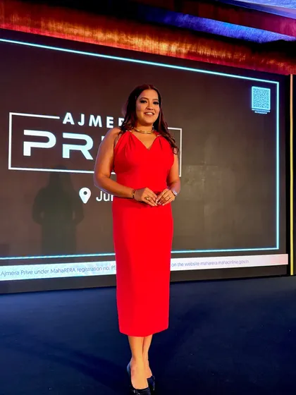 A smiling pose on stage at the Ajmera Privé launch.