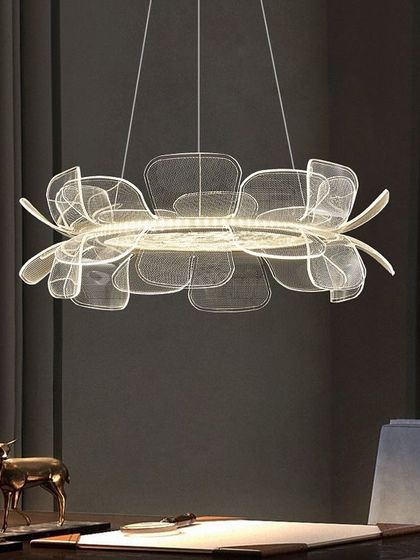 A delicate, flower-like chandelier with layered, translucent petals. This fixture provides soft, diffused light, ideal for creating a serene atmosphere in a dining room or entryway.