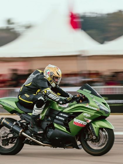A green Kawasaki Ninja ZX-14R, another hyperbike icon, is captured in a blur of motion, demonstrating its incredible acceleration.