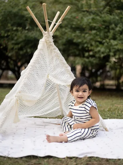 A happy smile from beside the teepee. Outdoor sessions allow kids to be themselves and explore.