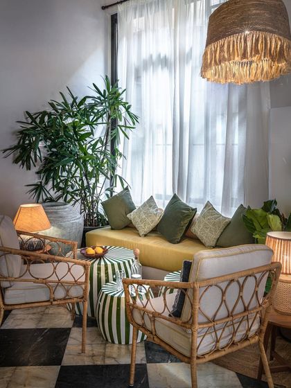 This cozy corner at EVE Bombay showcases our focus on creating a comfortable, at-home feel. The design mixes textures and patterns, from the checkered floor and striped stools to the woven chairs and soft cushions, all under the warm glow of ambient lighting.