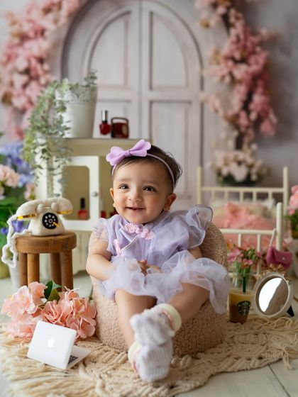 This little girl is ready for her close-up in a lovely lavender outfit, part of the versatile spa-themed setup.