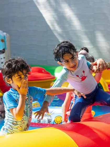 This action shot captures the playful energy of our pool parties. It is all about kids being kids, having fun, and making a splash.