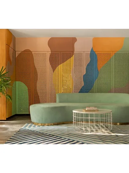 This view of the waiting area shows how we used a bold, striped rug to anchor the space and complement the colorful wall mural. The design is a joyful blend of pattern and color, designed to uplift and inspire.