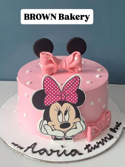A sweet Minnie Mouse cake for Aaria's first birthday. This is a vegan fruit-flavored cake, showing that we can accommodate dietary needs without sacrificing a fun design.