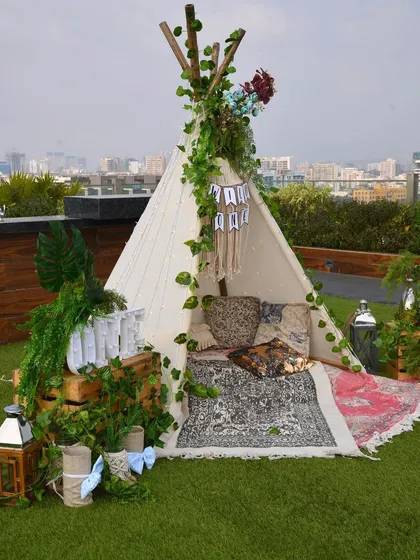A closer view of the teepee, styled with printed rugs, cushions, and lanterns to create a cozy and picture-perfect nook for the little one and guests.