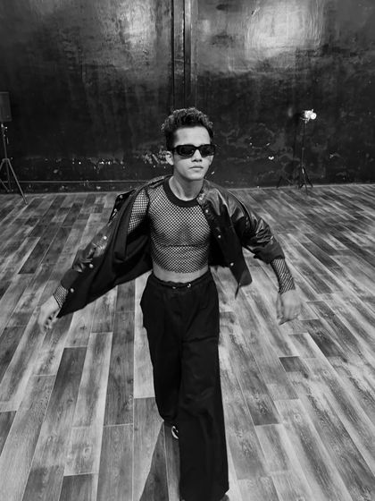 A black and white action shot, capturing a sense of movement and energy within the studio space.