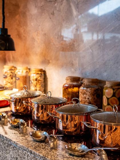 Our hot food station, featuring elegant copper pots, keeps our brunch dishes warm and ready to be served. This setup ensures that every dish, from curries to stews, is enjoyed at the perfect temperature.