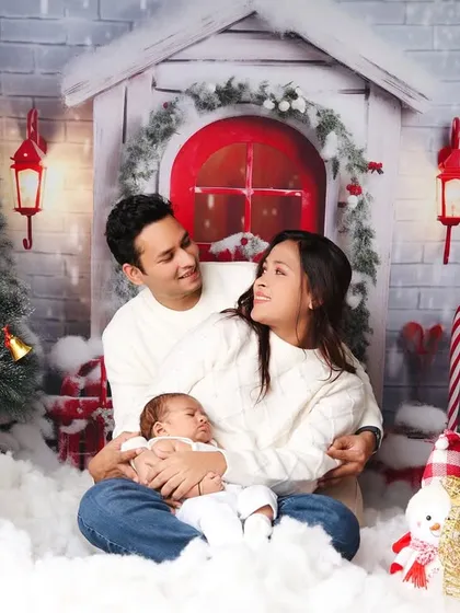 A candid, loving moment between parents and their baby during their first family Christmas photoshoot.