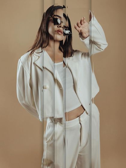 An experimental shot using reflections. The makeup remains a key part of the overall artistic vision, holding its own even with creative photo effects.