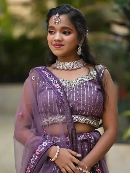 Makeup for the younger members of the bridal party is always fun. This 'sider' looks lovely in her purple lehenga with age-appropriate, soft glam makeup.