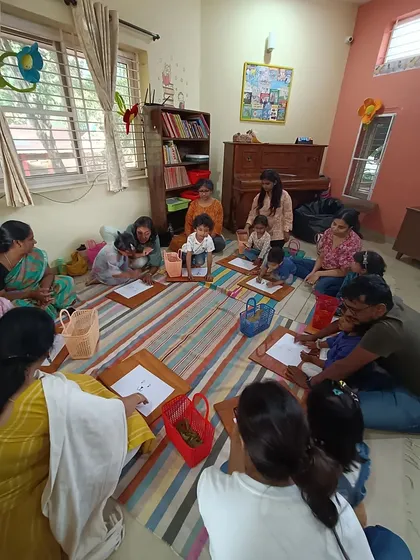 After a story about Little Vinayaka, children collected leaves from the garden to use in their craft, connecting the story to the natural world around them.