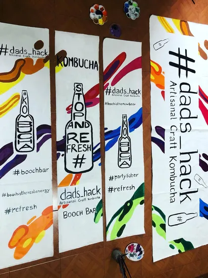 I hand-painted these banners for a kombucha brand's stall at a festival. To align with their sustainable approach, I reused and painted over old, discarded banners, giving them a vibrant new life.