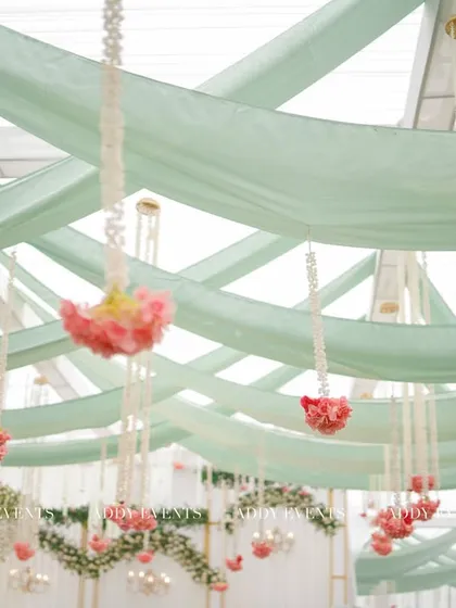 A view of the stunning ceiling treatment, with flowing pastel green drapes and hanging floral arrangements, which added a dreamy and romantic feel to the Nikah venue.
