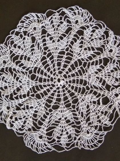 A 15-inch doily with a spider-web-like pattern.