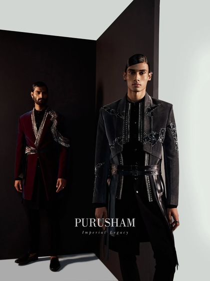Magnificence that spills grandeur. This image captures the commanding presence of two men in my winter collection, featuring a grey belted jacket and a wine-colored velvet piece with silver lapels.