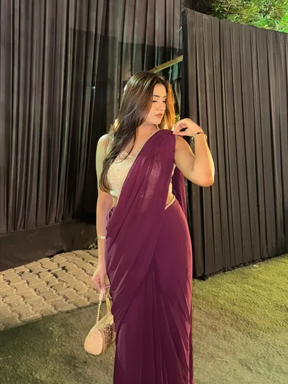 Adjusting the pallu of my saree, a classic, graceful pose that highlights the beauty of the garment.