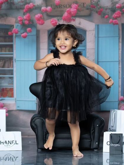 This little fashionista is ready for a shopping spree in Paris, surrounded by Chanel bags.