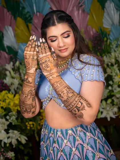Here is a beautiful bride on her special day, showing how my intricate henna design complements her modern lehenga. The full-sleeve mehendi adds a layer of tradition and elegance to her overall look.