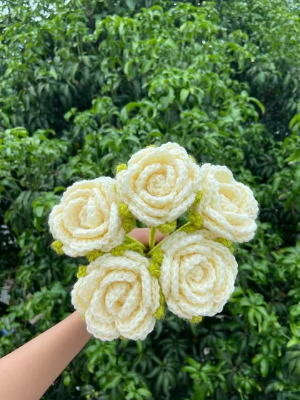 A simple and classic bouquet of five white roses.