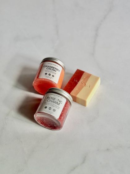 A product shot showcasing our customizable Self-Care Bundle. This one features our Cranberry Crush and Rose-tic Charm polishes with a Sweet Rose soap bar.