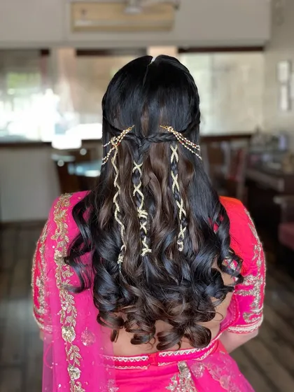 I love getting creative with half-up styles. Here, I incorporated small braids and gold strings for a bohemian-inspired look.