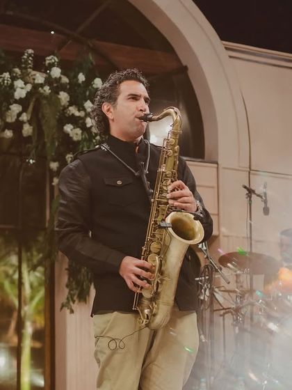 The saxophonist from the jazz quartet, adding a smooth and soulful sound to the cocktail soirée.