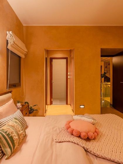 A tranquil bedroom where soft pink and beige tones create a soothing atmosphere. The chunky knit throw and plush pillows add layers of comfort, making this a perfect space to unwind.