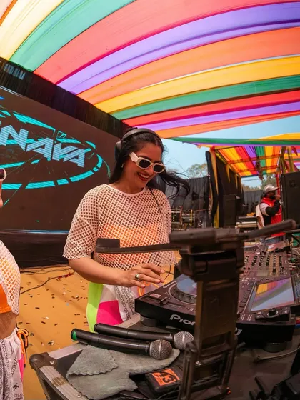 A close-up shot of me at the decks during the Holi party. Even with a massive crowd, I'm focused on delivering the perfect mix.