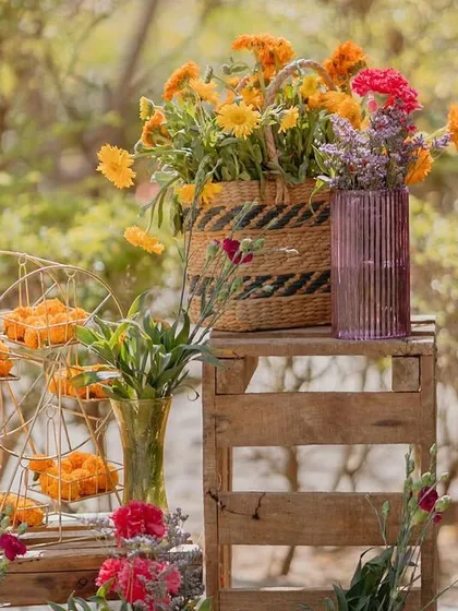 A rustic display of flowers in baskets and crates, adding to the 'mela' vibe of the 'Rajasthani Folklore' Mehendi.