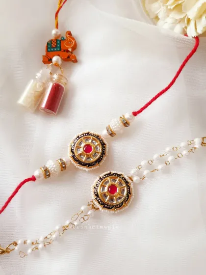 This is one of my favorite Bhai Bhabhi Rakhi sets. The traditional Kundan work on the bhai rakhi pairs perfectly with the delicate pearl Lumba for bhabhi. This set comes with Roli-Chawal to complete your Raksha Bandhan ceremony.