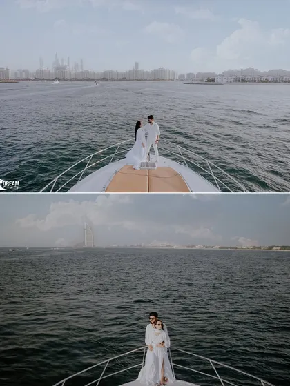 A wide-angle shot capturing the couple on a yacht, showcasing the vastness of the sea and the distant, iconic silhouette of the Burj Al Arab.