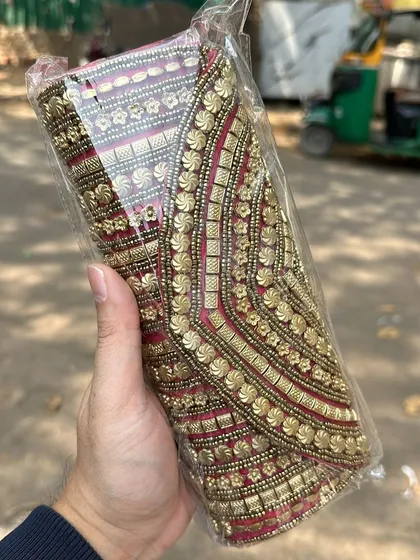 A stunning beaded and embroidered clutch bag. The rich red and gold design is perfect for weddings or special occasions.